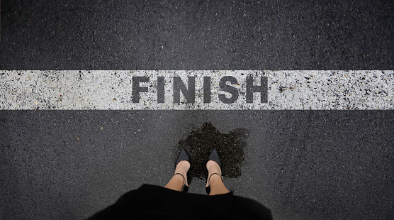 Dress shoes standing next to finish line