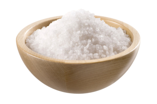 Sea salt in a  wooden bowl  isolated on white