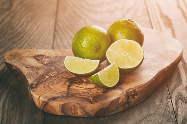 istock ripe limes on olive board over oak table 915131448