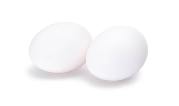 istock Group of two white eggs isolated on white background 915133224