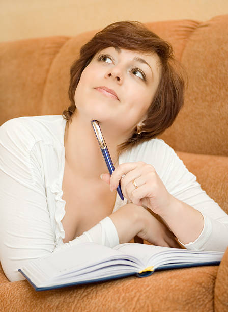 istock Young woman with notepad or organiser writing 91513439