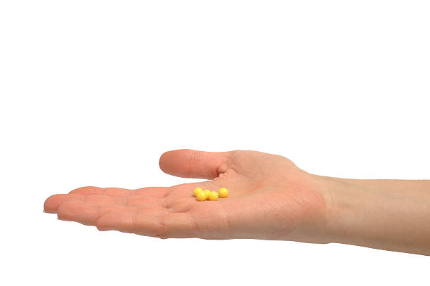 Woman's hand holding pills stock photo