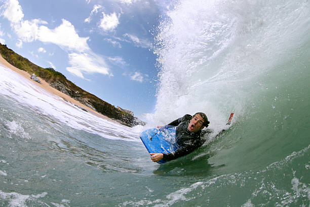 Bodyboarder Riding Powerful Wave A young man surfing a powerful wave on the north coast of cornwall in england. Please see some similar pictures from my portfolio:  body board stock pictures, royalty-free photos & images