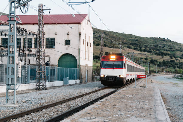 istock Train entering old railroad station platform in countryside 915140648