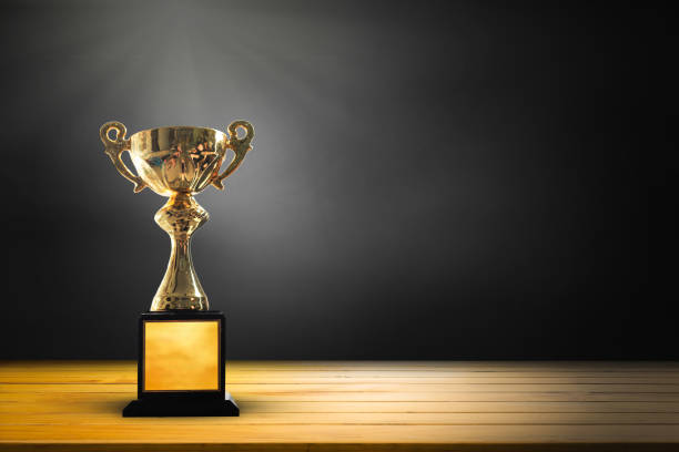 istock Champion golden trophy on wooden table background. copy space for text. 915140858
