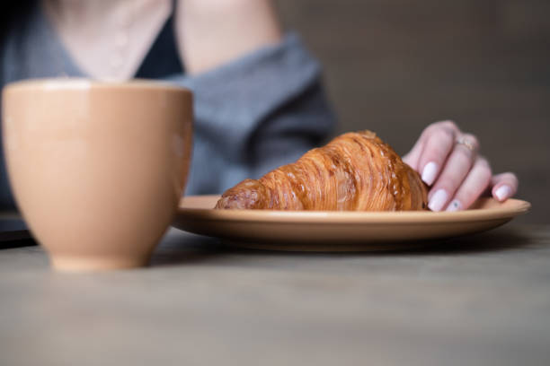 istock Woman holding delicius croissant 915143696
