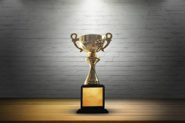 istock Champion golden trophy on wooden table background. copy space. 915143902