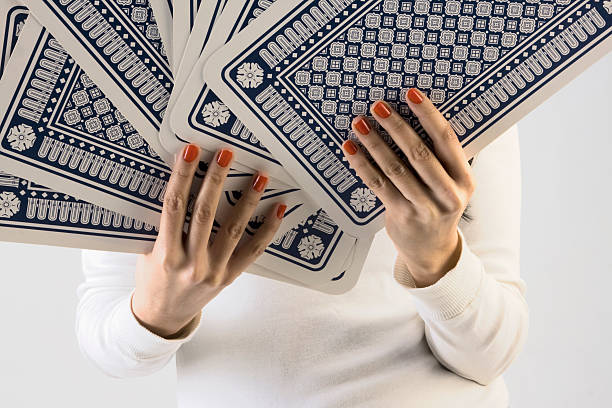 Close-up of a hand with Italian cards. Family playing board game indoors.