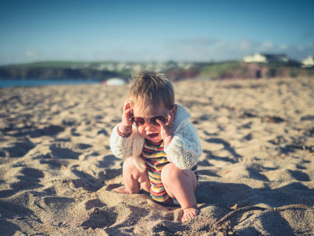 istock Baby with sunglasses on the beach 915146858