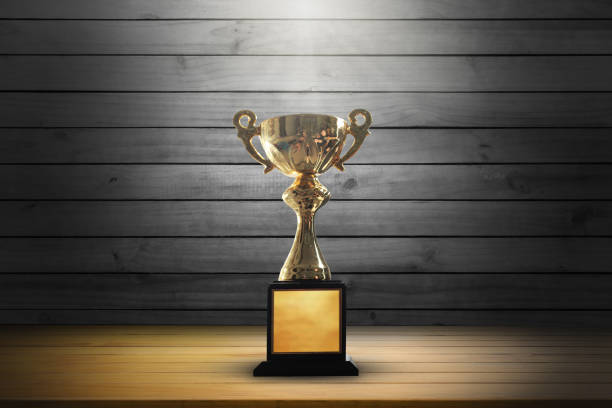 istock Champion golden trophy on wooden table background. copy space. 915150452