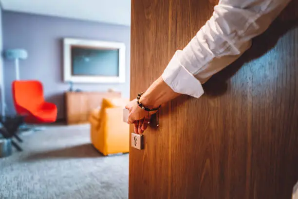Photo of Man hand opening the door of the luxurious hotel room