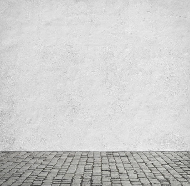 White wall of the house Old white wall and cobblestone floor. cobblestone photos stock pictures, royalty-free photos & images