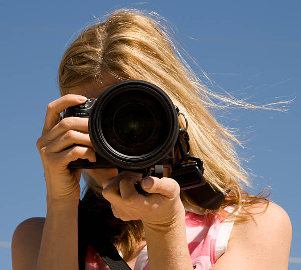 istock Woman Holding an SLR Camera 91515737