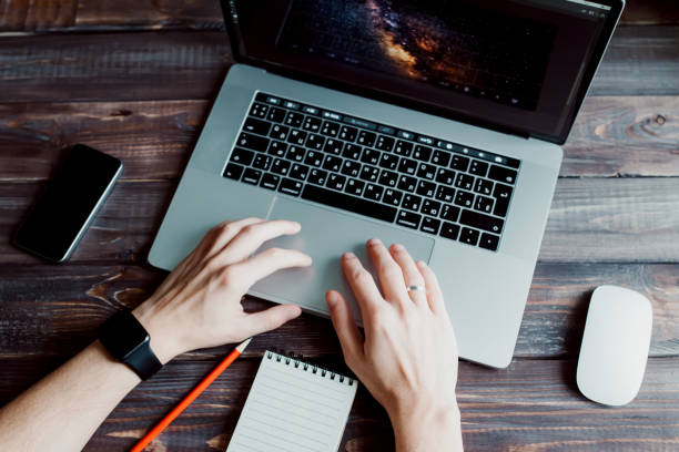 istock Man designer is working using laptop computer and graphics tablet at home office. Professional occupation workplace 915160344