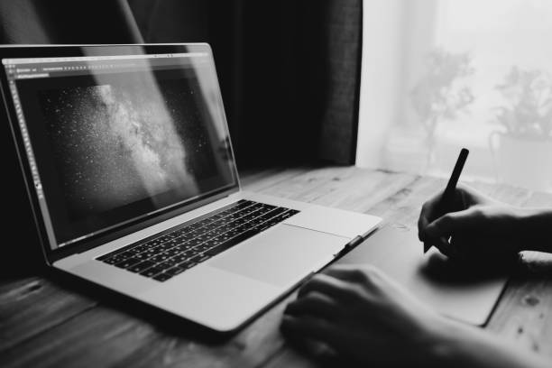 istock Man freelancer is working using laptop computer and graphics tablet at home office. Freelance lifestyle workplace 915160524