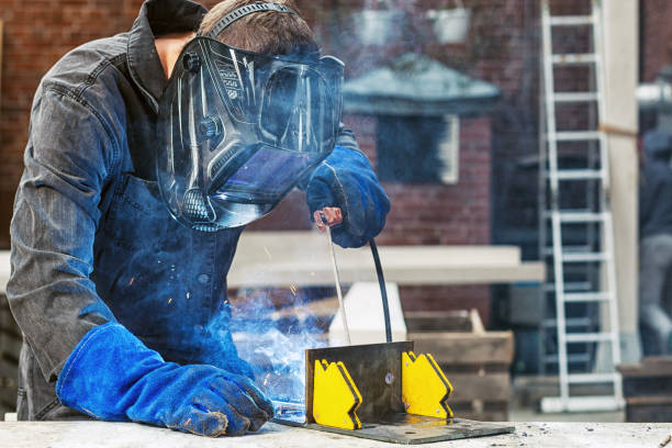 istock man  welds a metal welding 915176222