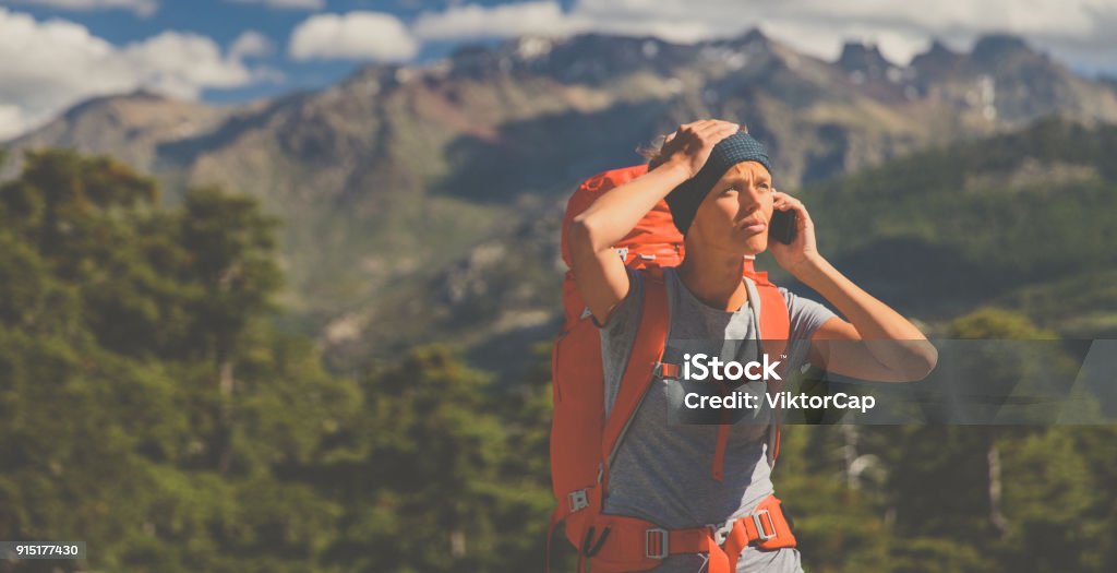 Pretty, female hiker in high mountains , calling for help Pretty, female hiker in high mountains , calling for help - being injured and lost Hiking Stock Photo