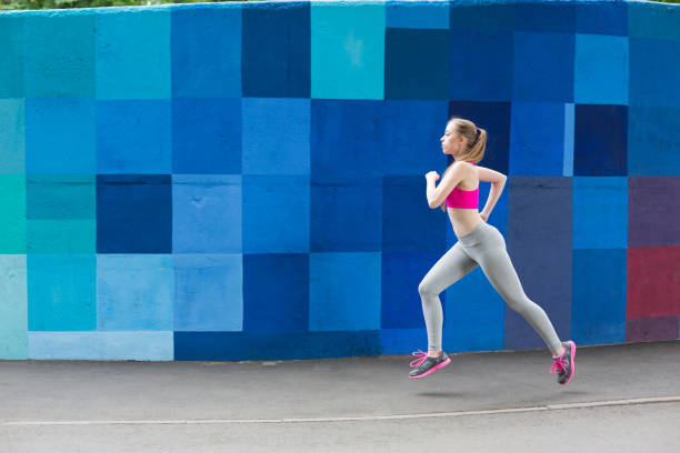 istock Young woman running in city copy space 915179036
