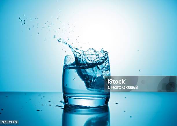 Pure Water Splashing Out Of Glass Stock Photo - Download Image Now - Water, Drinking Glass, Drop
