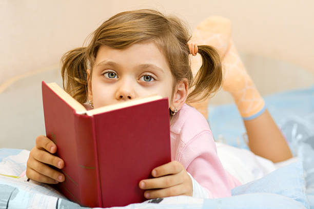 istock Young girl reading a book on bed 91517970