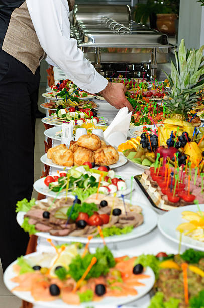 istock Server arranging food ready for banquet buffet 91518061
