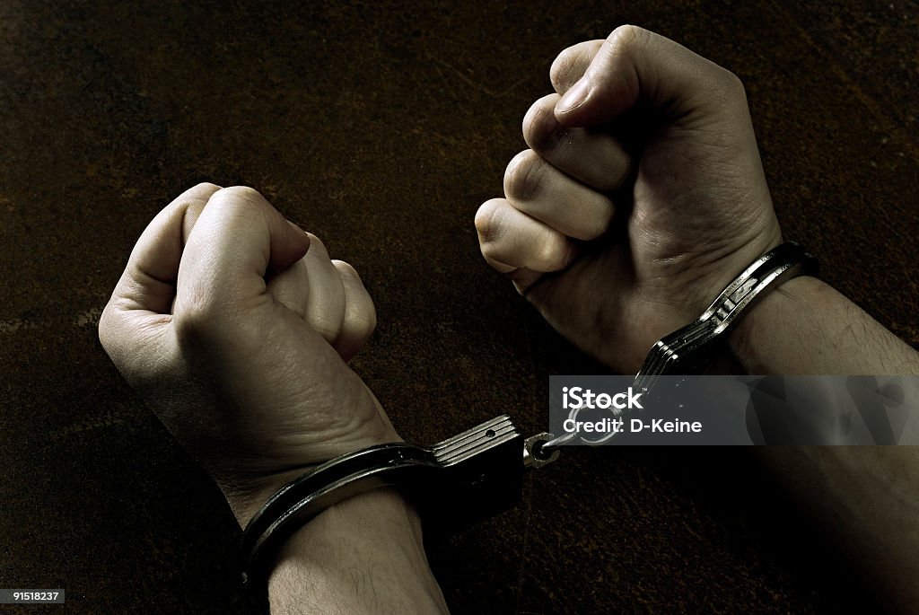 Handcuffs Male hands in handcuffs Arrest Stock Photo