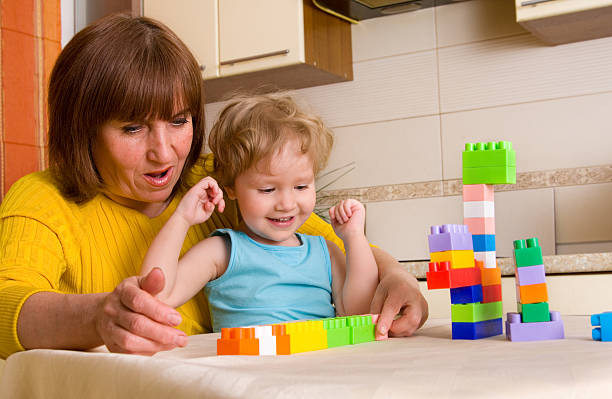 istock Baby with grandmother plays cubes 91518254