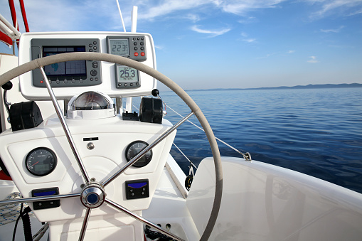 Steering wheel on luxury yacht cabin