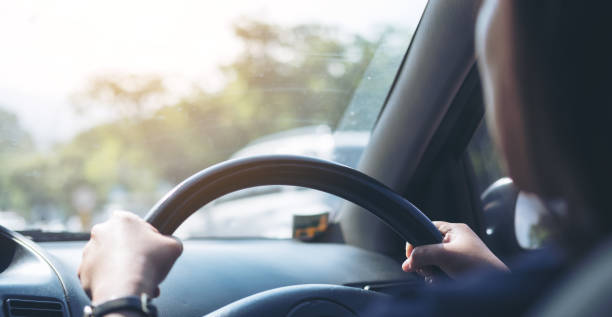 istock Woman holding on black steering wheel while driving a car 915185686