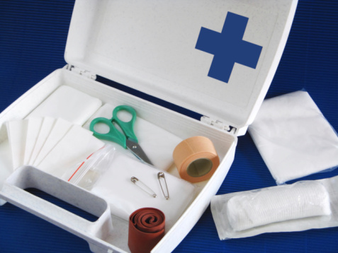 Open first aid kit - still life - blue background