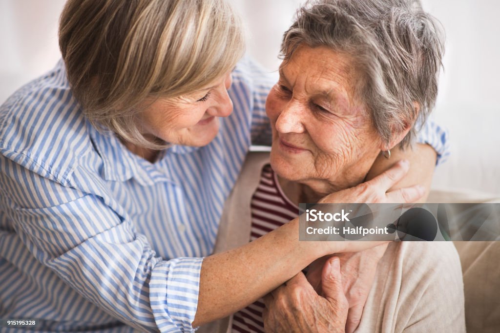 Senior women at home. Two senior women at home, hugging. Family and generations concept. Senior Adult Stock Photo