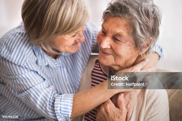Senior Women At Home Stock Photo - Download Image Now - Senior Adult, Embracing, Daughter
