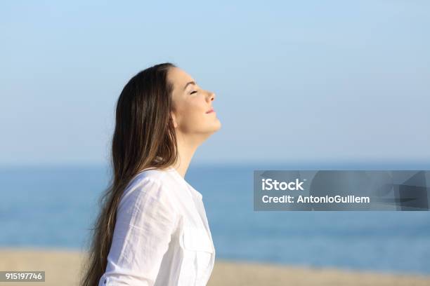 Woman Relaxing Breathing Fresh Air On The Beach Stock Photo - Download Image Now - Breathing Exercise, Inhaling, Women