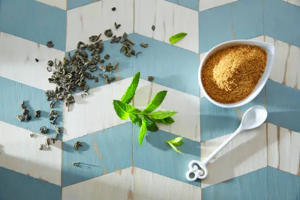 green tea ingredients Moroccan style on wood blue white table
