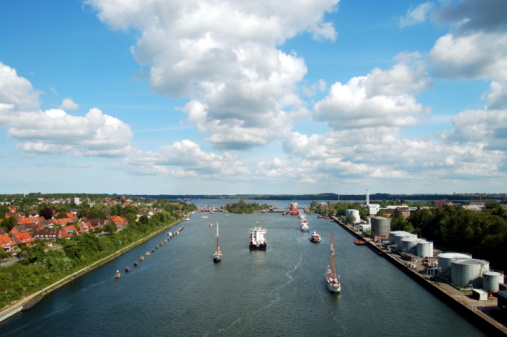 Dorsten, North Rhine-Westphalia, Germany - May 07, 2020: A freight ship on the Wesel-Datteln Canal with the Dorsten sluice in the background