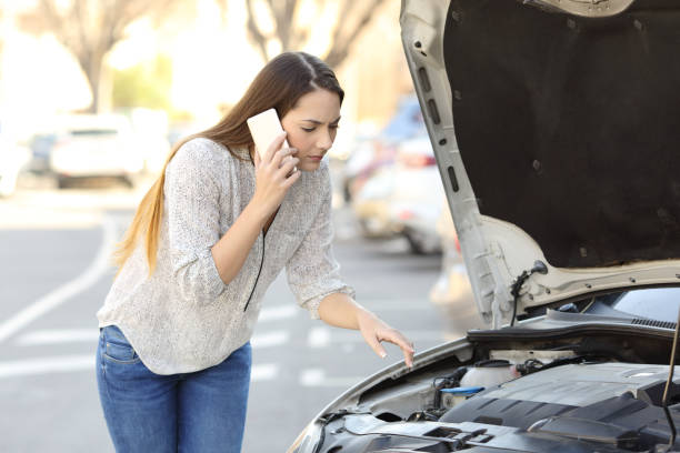 istock Worried driver with car breakdown calling insurance 915205588