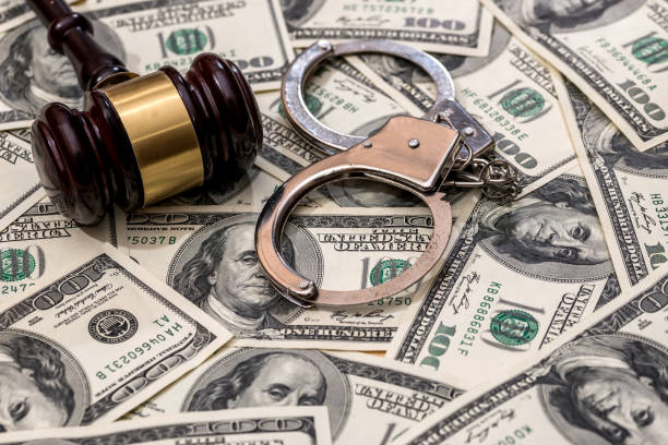 istock finance or crime concept - handcuffs dollar and gavel 915205668