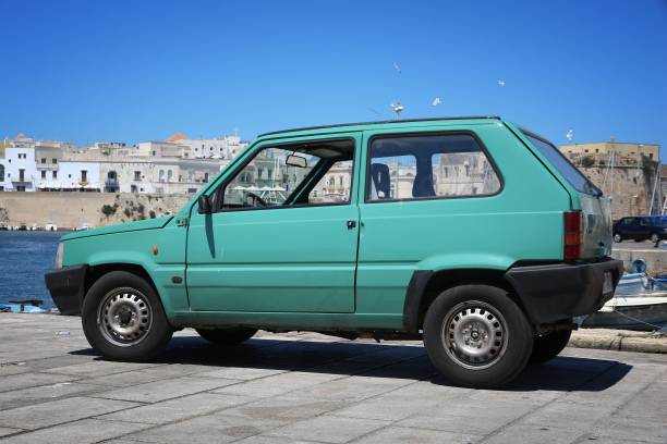 Old Fiat Panda Gallipoli: Fiat Panda retro oldtimer hatchback car parked in Italy. There are 41 million motor vehicles registered in Italy. little fiat car stock pictures, royalty-free photos & images