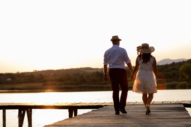 istock Romantic young couple on lake pier 915206558