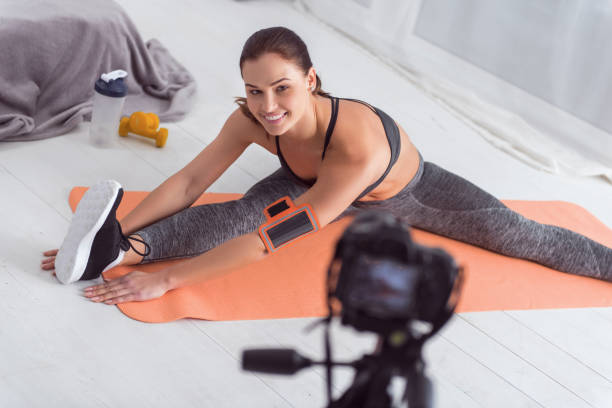 istock Cheerful young woman stretching for camera 915206786