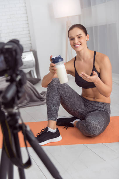 istock Joyful muscular blogger holding a drink for camera 915209918