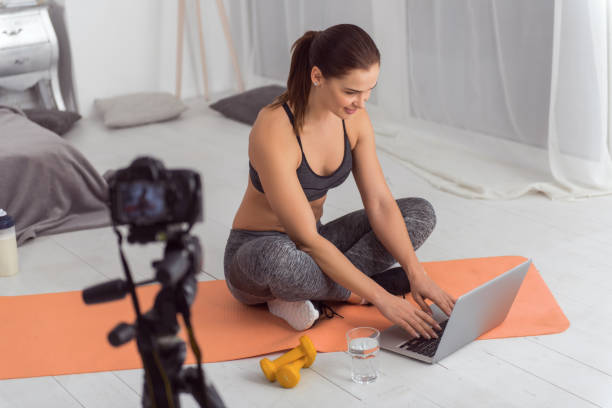 istock Happy blogger using her laptop and making a video 915210028