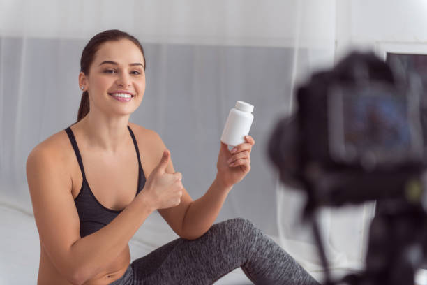 istock Vigorous blogger holding a bottle for cam 915210132