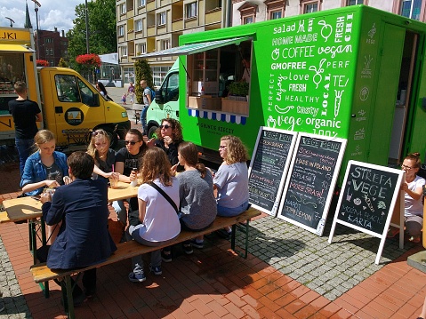 Bytom: People eat at a food truck in Bytom, Poland. Food truck culture has been gaining momentum all over Europe in recent years.