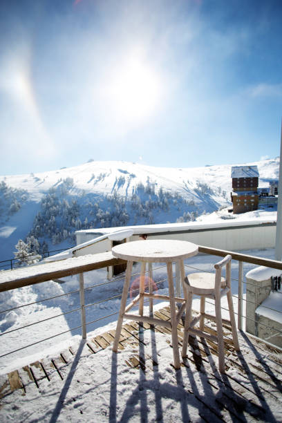 istock Empty Chair and Table on a Snowy Winter Terrace 915213680
