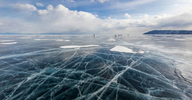 istock view of ice water surface under cloudy sky during daytime and group of hikers on background , russia, lake baikal 915217890