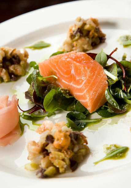 Uncooked salmon on rocket salad