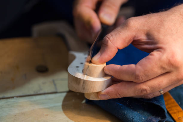 istock craftsperson carving violin 915226732