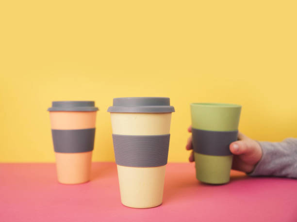 istock Take away coffee cups on colorful paper background 915229552