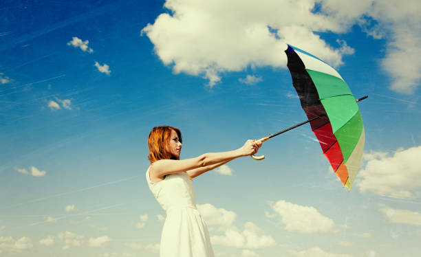 istock Young redhead woman with umbrella 915229764